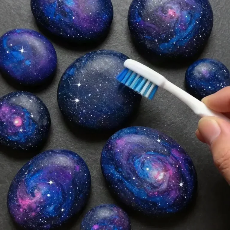 Colorful galaxy painted pebbles with swirling stars and cosmic designs