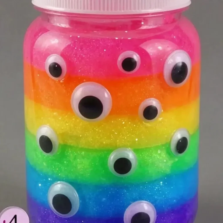 Colorful rainbow glowing monster slime in a jar