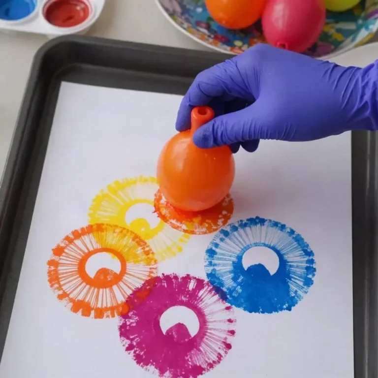 Children enjoying water balloon painting DIY project with colorful paint and pinwheels.